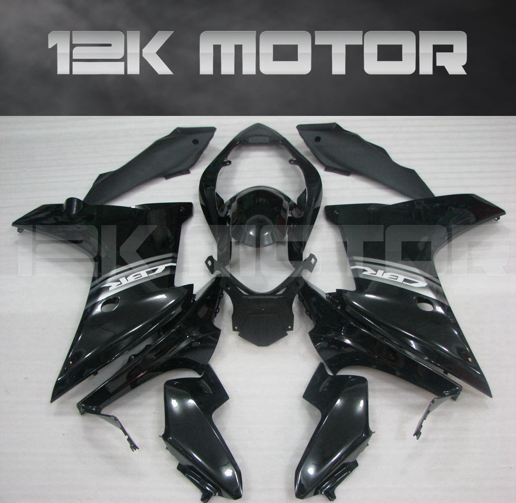 Aftermarket black fairing kit for HONDA CBR600F 2011-2013 displayed on a table.