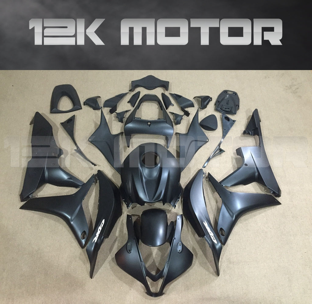 Matt black fairing kit for HONDA CBR600RR displayed on a table, including various motorcycle fairing panels and parts.