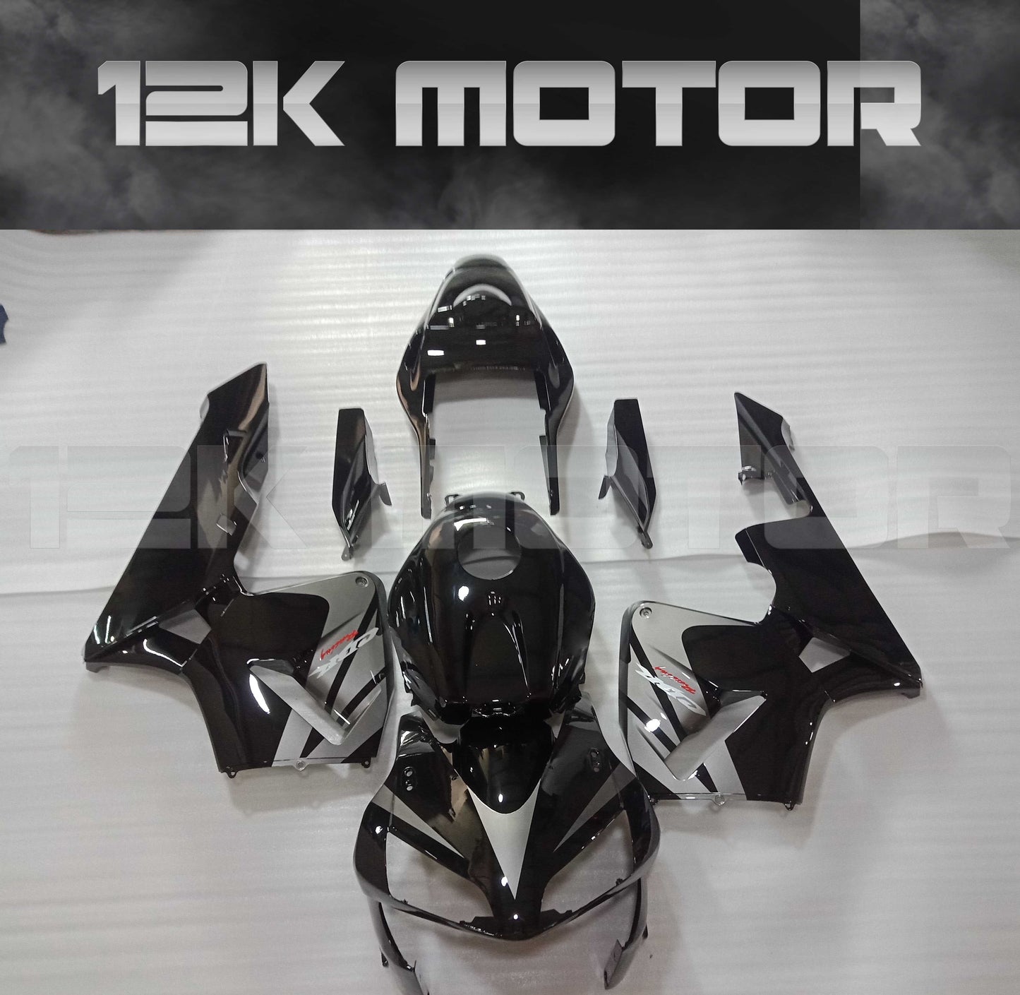 Black and silver fairing kit for HONDA CBR600RR, displayed on a table.