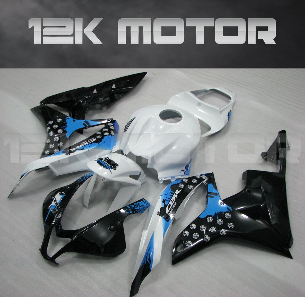 Aftermarket black, white, and blue fairing kit for Honda CBR600RR motorcycle, displayed on a table.