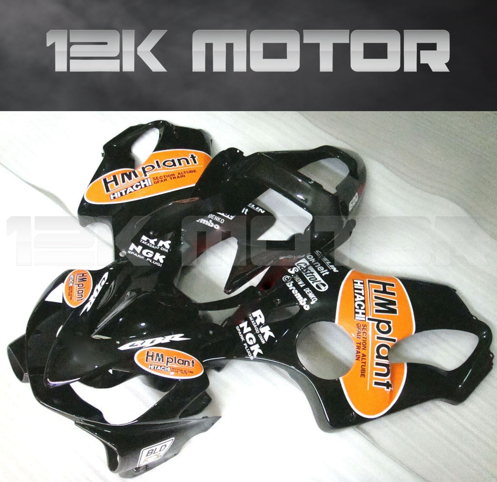 Aftermarket fairing kit for HONDA CBR600 F4i 2001-2003, displayed on a table, consisting of multiple black plastic panels with orange and white branding stickers.