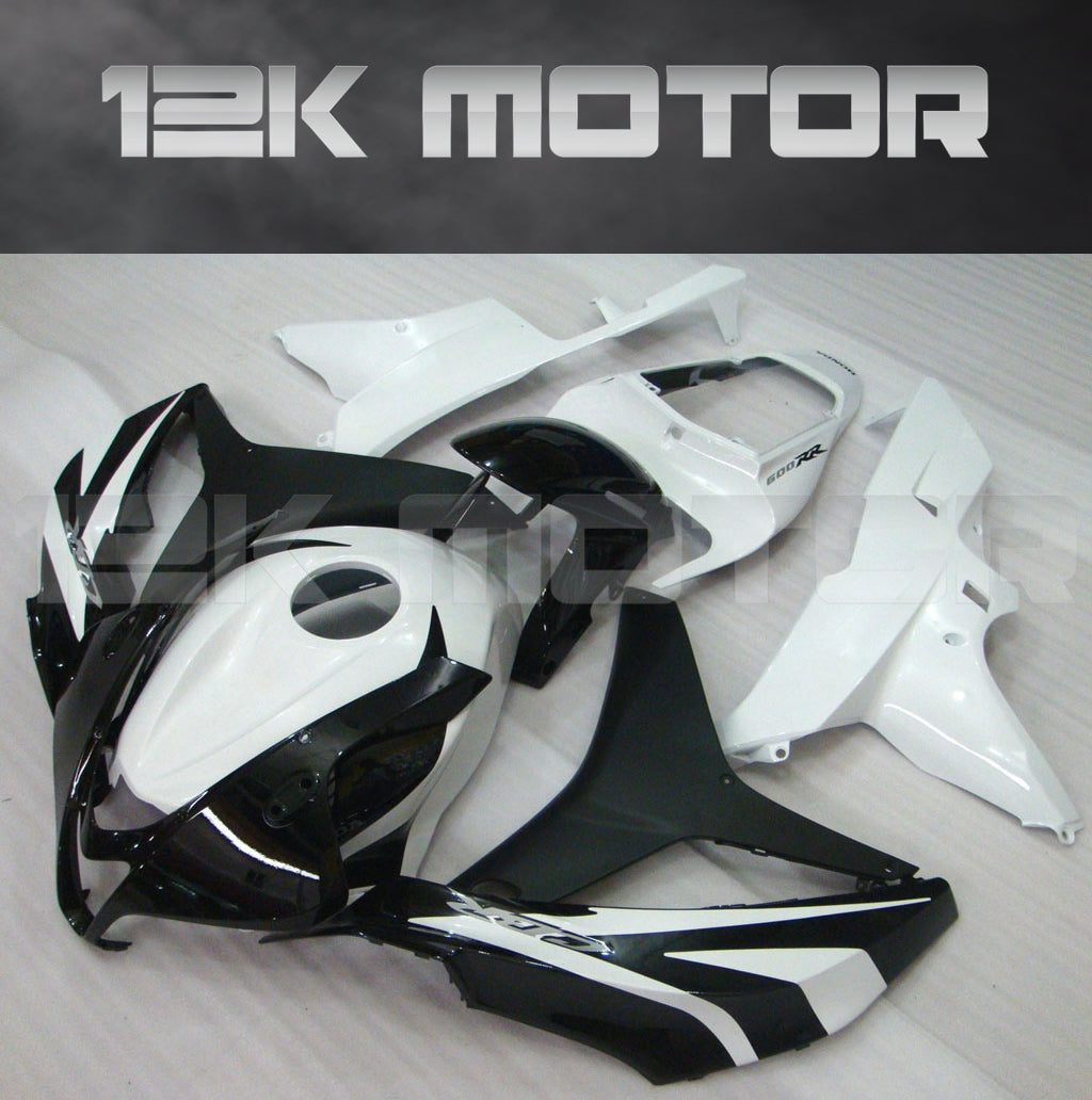 Aftermarket black and white fairing kit for Honda CBR600RR motorcycle, displayed without the motorcycle.