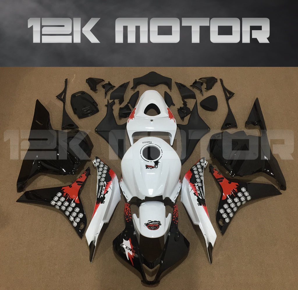 Aftermarket motorcycle fairing kit for Honda CBR600RR displayed on a table, featuring black, white, and red colors.