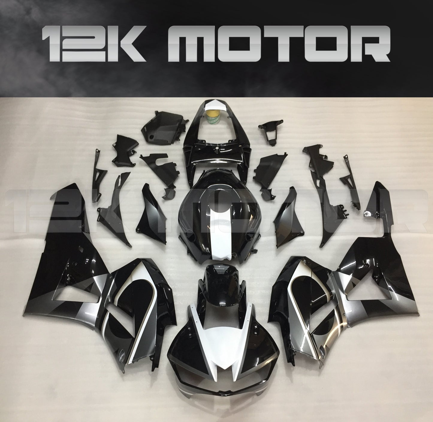Aftermarket black fairing kit for Honda CBR600RR motorcycle, displayed on a table with the brand name 12K Motor visible.