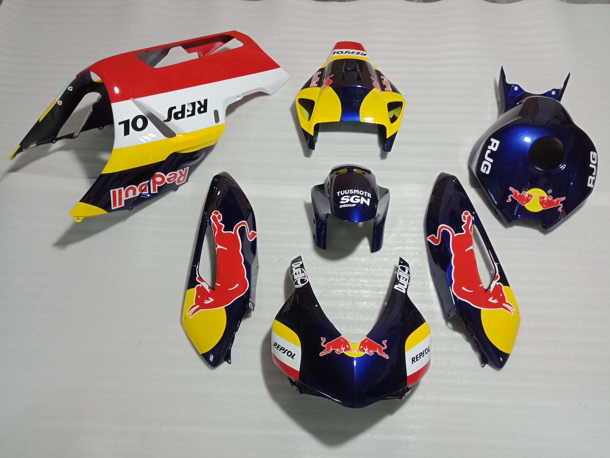 A set of Honda CBR1000RR motorcycle fairings with a red, white, and blue color scheme and sponsor logos.