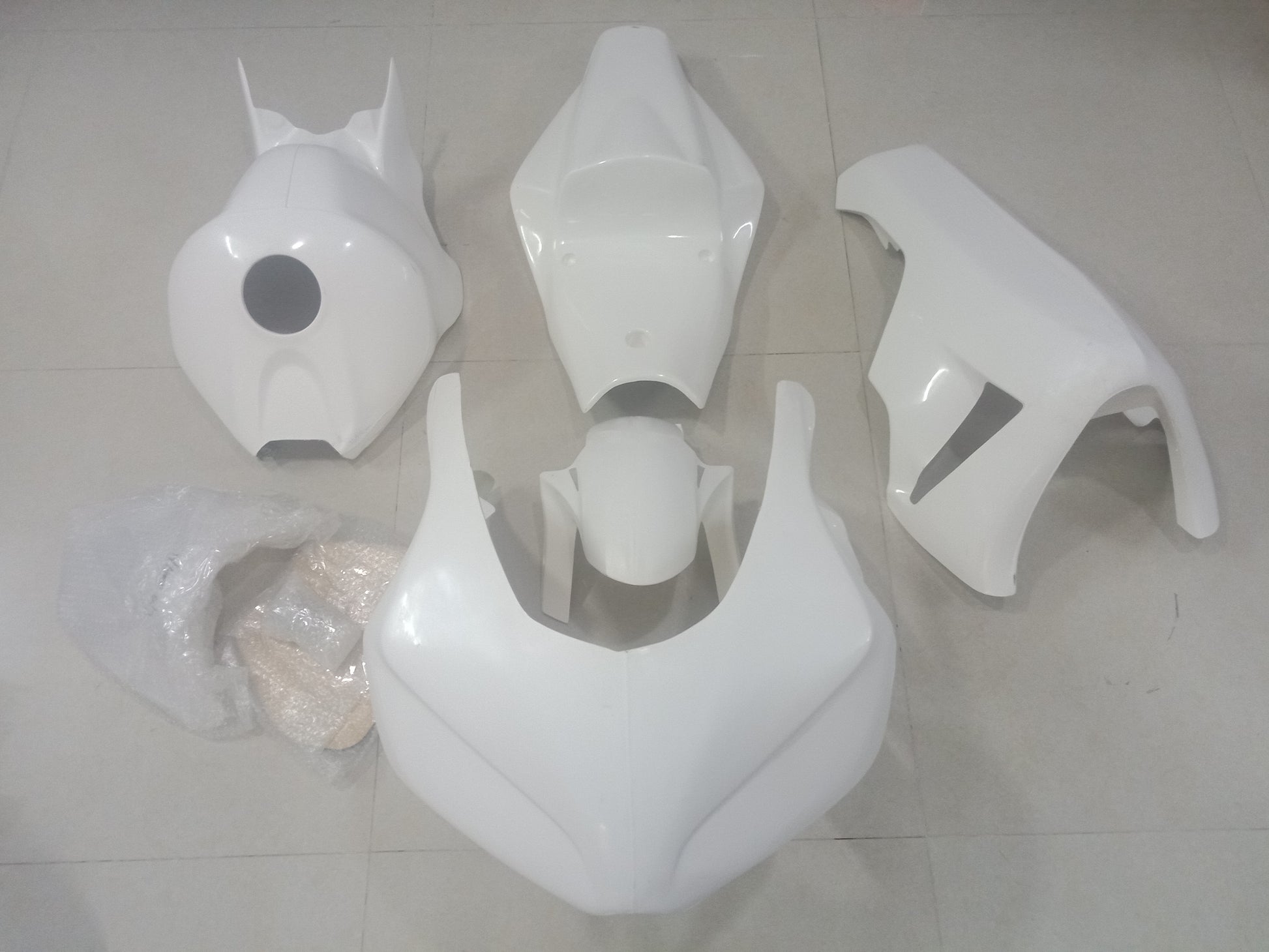 Unpainted fiberglass fairing kit for HONDA CBR1000RR motorcycle laid out on a flat surface.
