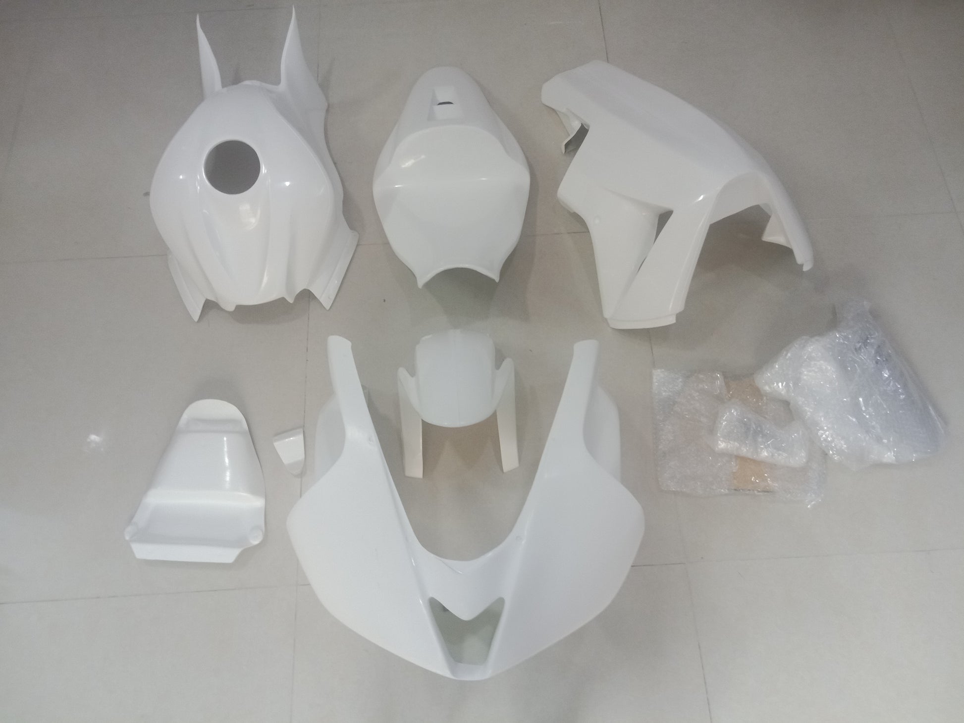 Unpainted fiberglass fairing kit for HONDA CBR600RR motorcycle laid out on a white surface.