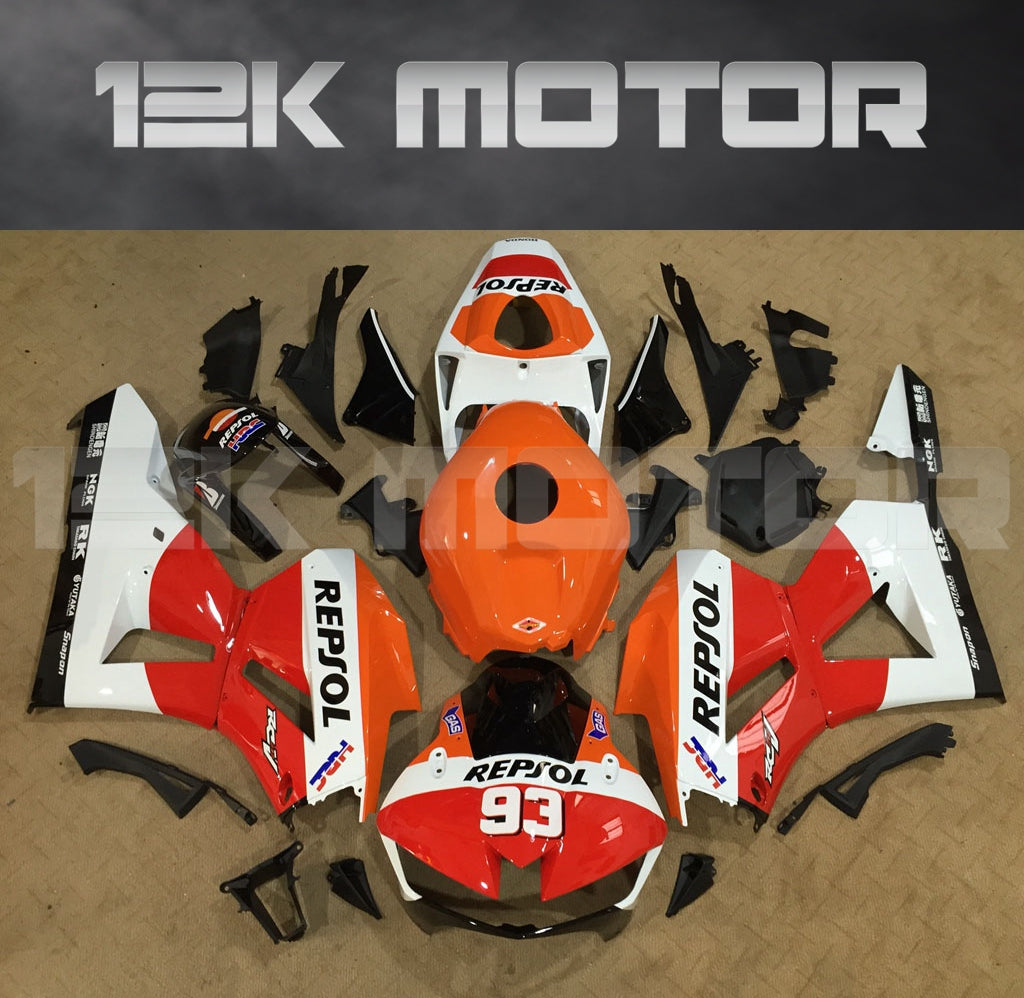 A collection of motorcycle fairing panels in various colors, including red and white, with the text '12K MOTOR' prominently displayed.