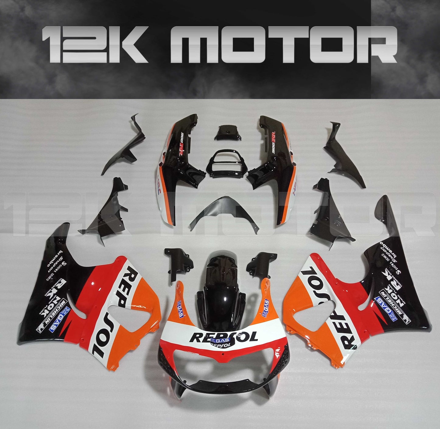 Aftermarket fairing kit for HONDA CBR900RR in orange, black, and white colors, including various panels and bolts, displayed on a plain background.