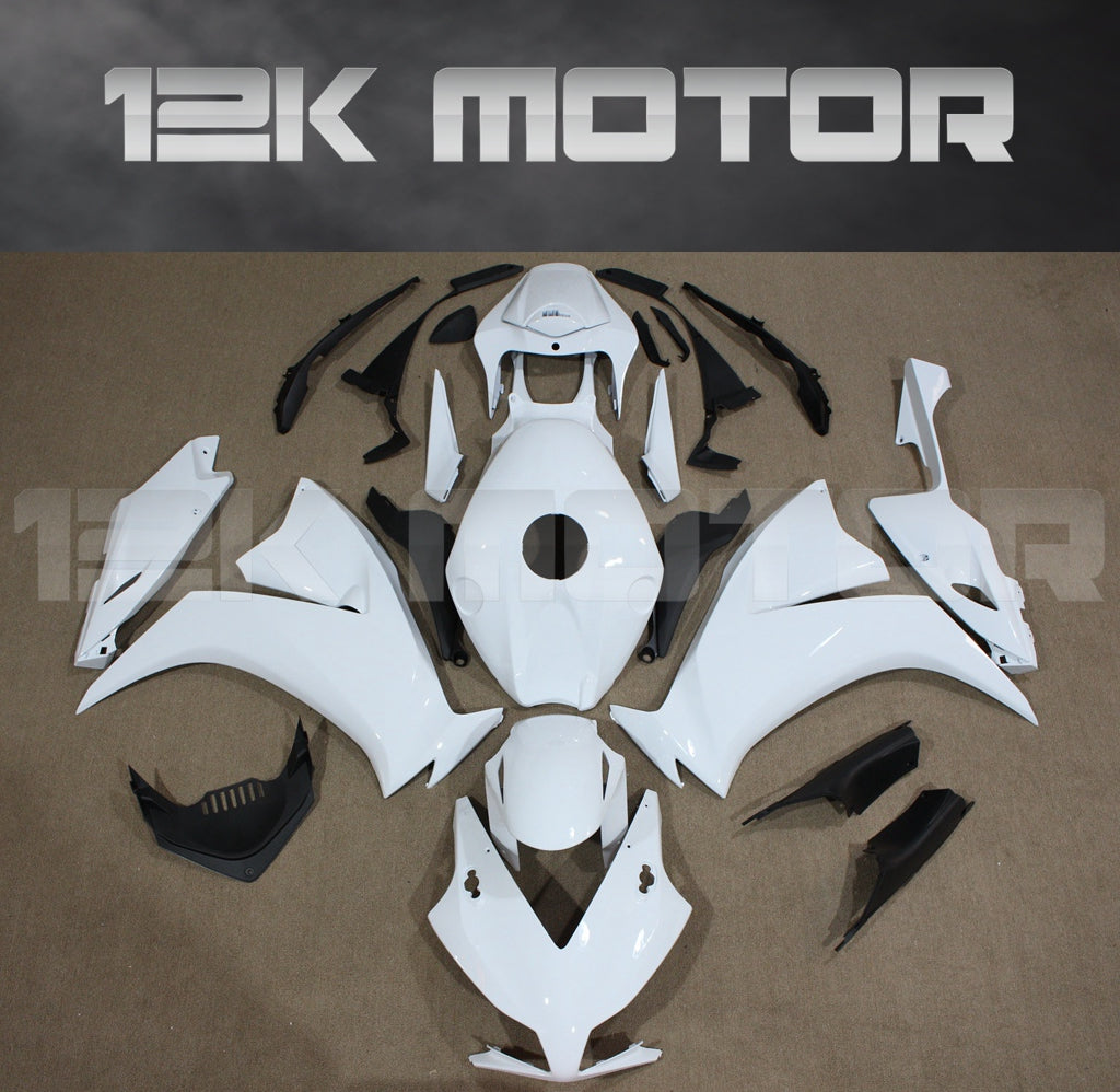 Aftermarket plain white fairing kit for HONDA CBR1000RR laid out on a flat surface, including various panels and parts.