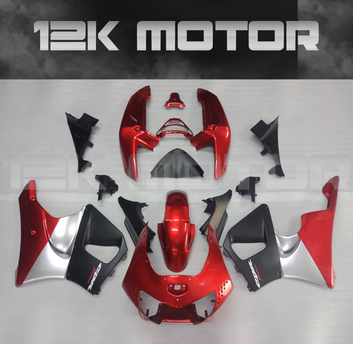 Aftermarket fairing kit for HONDA CBR900RR motorcycle, displayed on a table, featuring a red and black color scheme with various fairing pieces laid out separately.