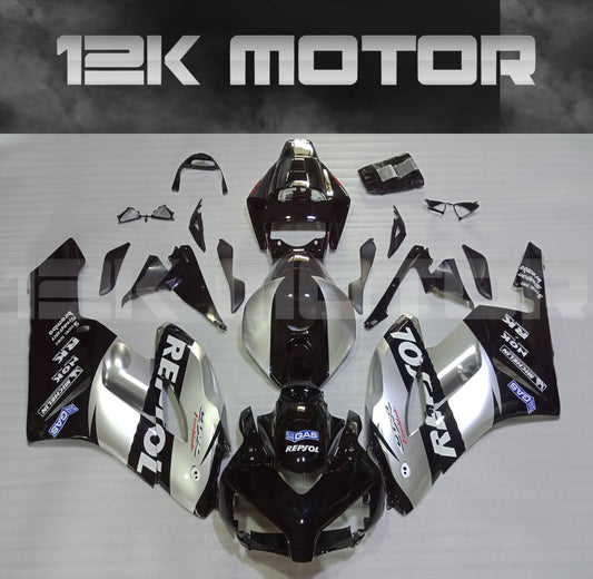 Aftermarket silver and black fairing kit for HONDA CBR1000RR motorcycle, displayed on a table.