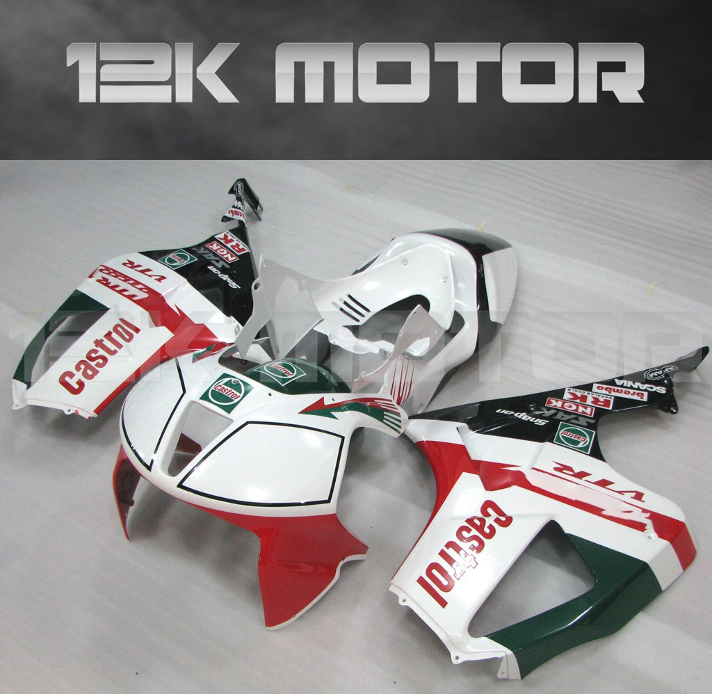 A set of Honda motorcycle fairings laid out on a surface, predominantly in red, white, and green colors with black accents, including a front mudguard and a full rear duck tail fairing.