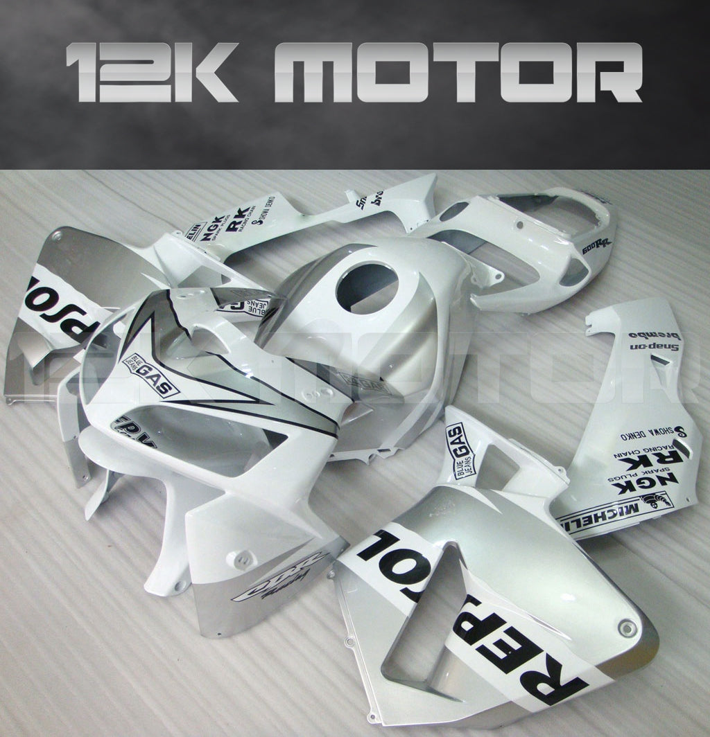 Aftermarket fairing kit for HONDA CBR600RR displayed on a table, consisting of various pieces in white with black text and graphics.