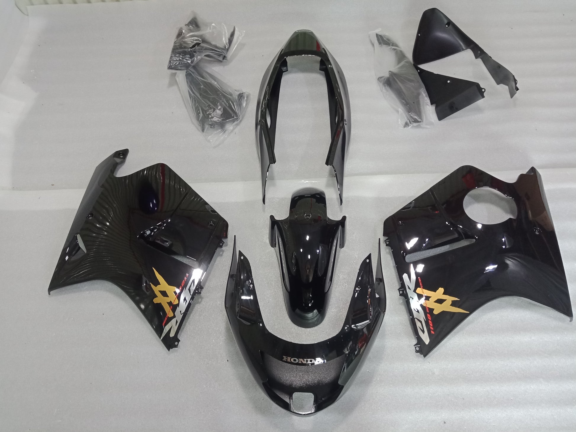 Motorcycle bodywork pieces with branding on a white background