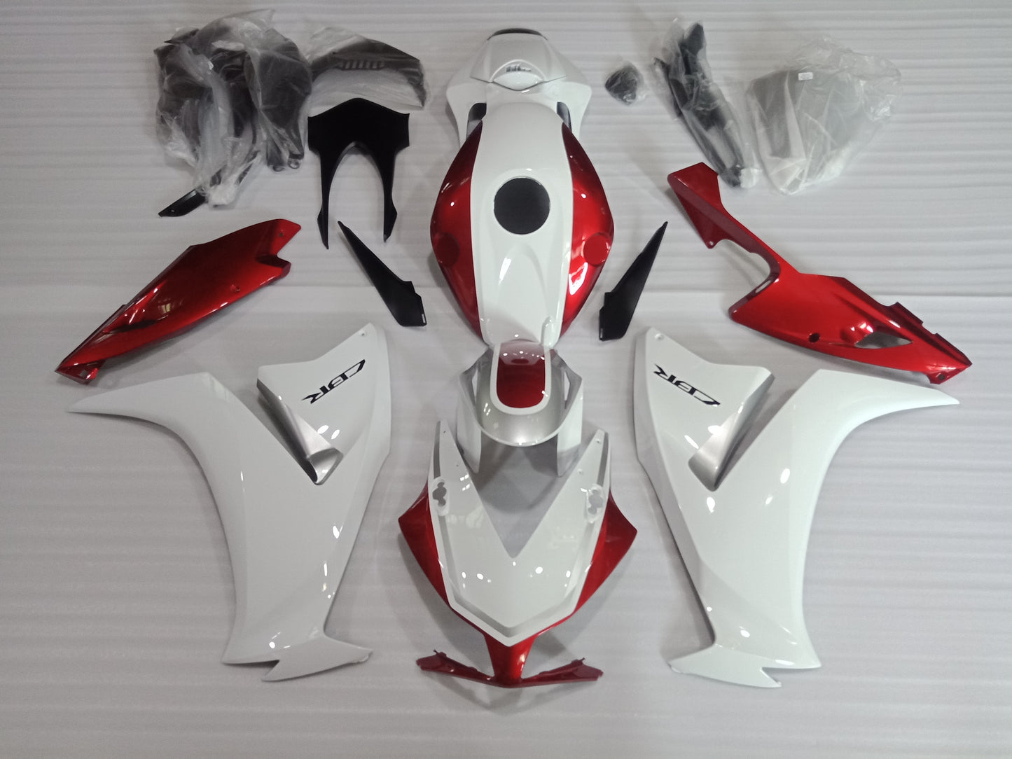 Aftermarket candy red fairing kit for Honda CBR1000RR 2012-2016, including various panels and fairing parts.
