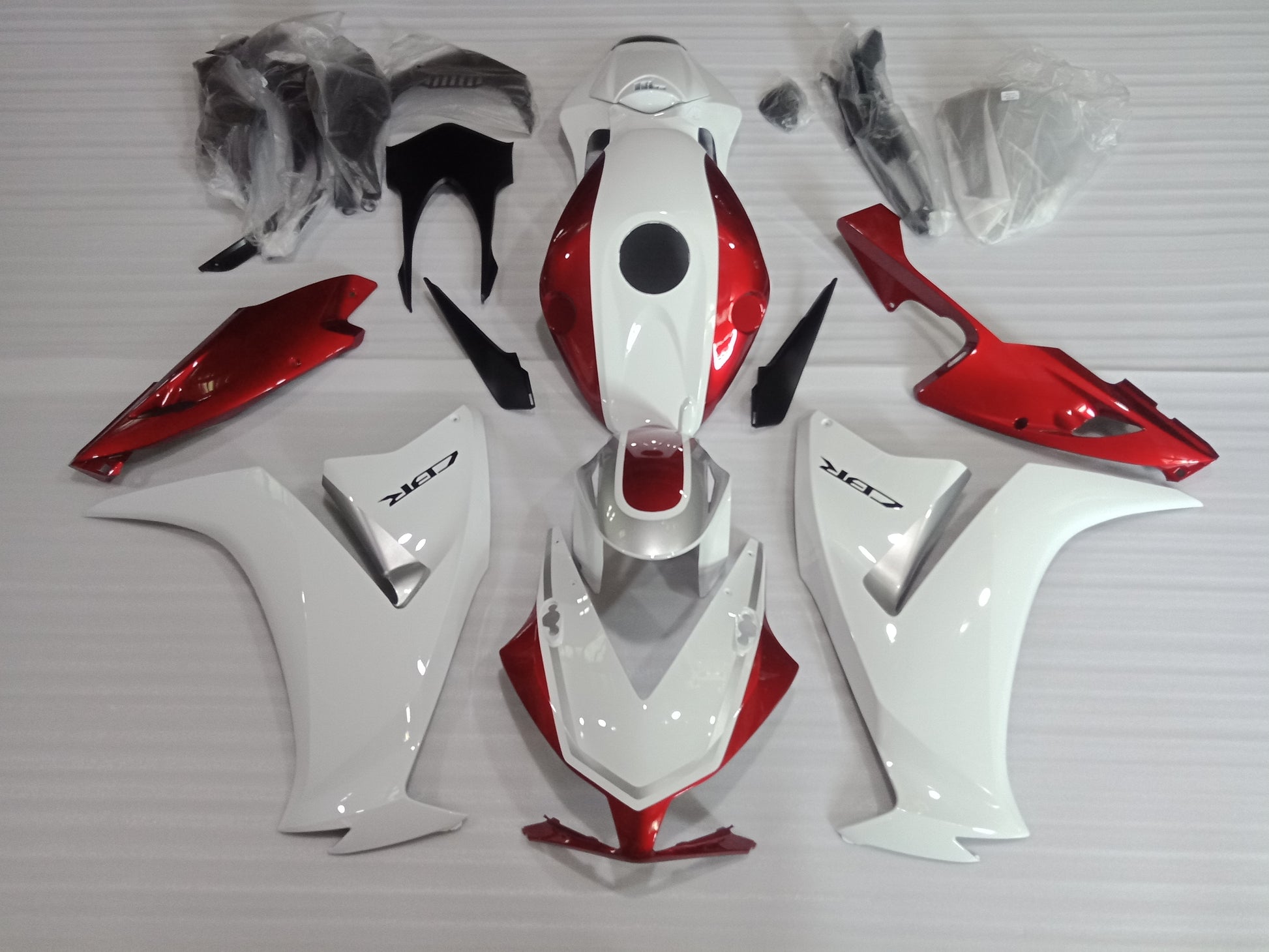 Aftermarket candy red fairing kit for Honda CBR1000RR 2012-2016, including various panels and fairing parts.
