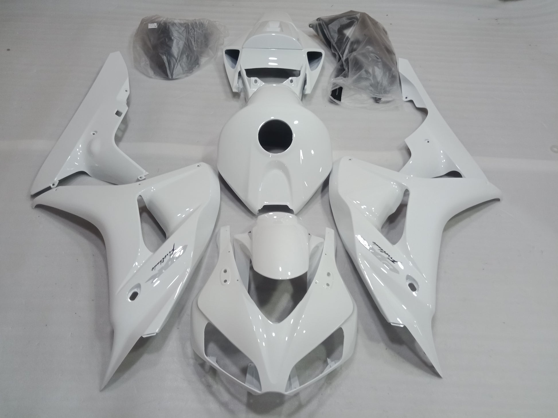 White fairing kit for Honda CBR1000RR motorcycle, displayed without being installed, including various panels and fairing parts.