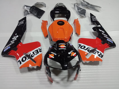 Aftermarket Repsol fairing kit for Honda CBR600RR, featuring orange, black, and white panels with sponsor logos.