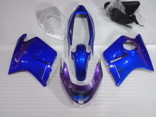 Aftermarket black fairing kit for Honda CBR1100XX motorcycle, displayed on a table with various pieces separated for assembly.