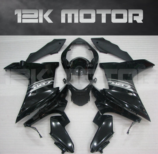 Aftermarket black fairing kit for HONDA CBR600F 2011-2013 displayed on a table.