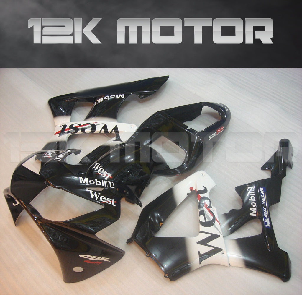 Aftermarket fairing kit for HONDA CBR929RR 2000 2001 displayed on a table, consisting of multiple black fairing pieces with white and red graphics, including text and logos.