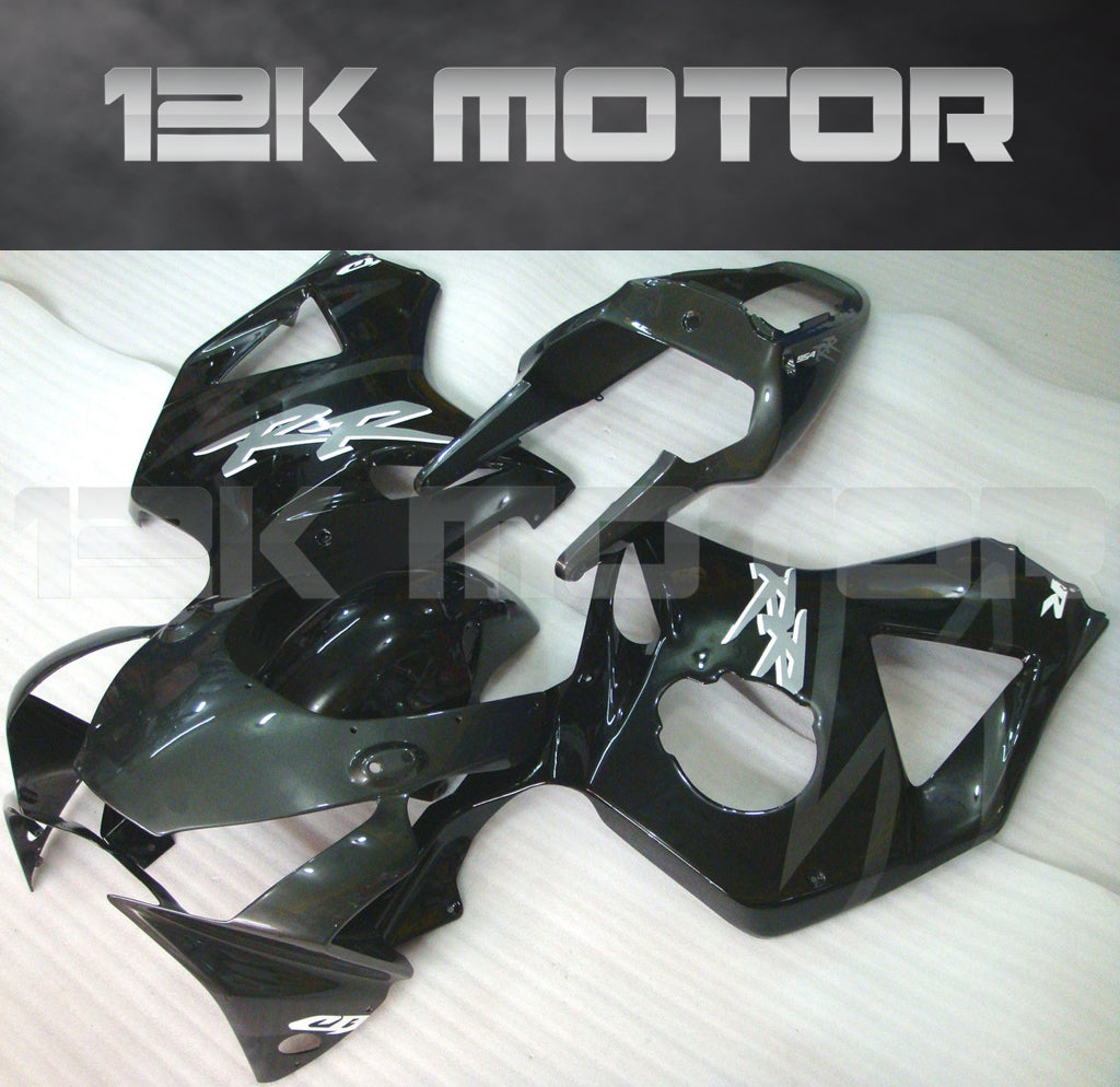 Aftermarket black fairing kit for HONDA CBR954RR 2002 2003 laid out on a white surface.