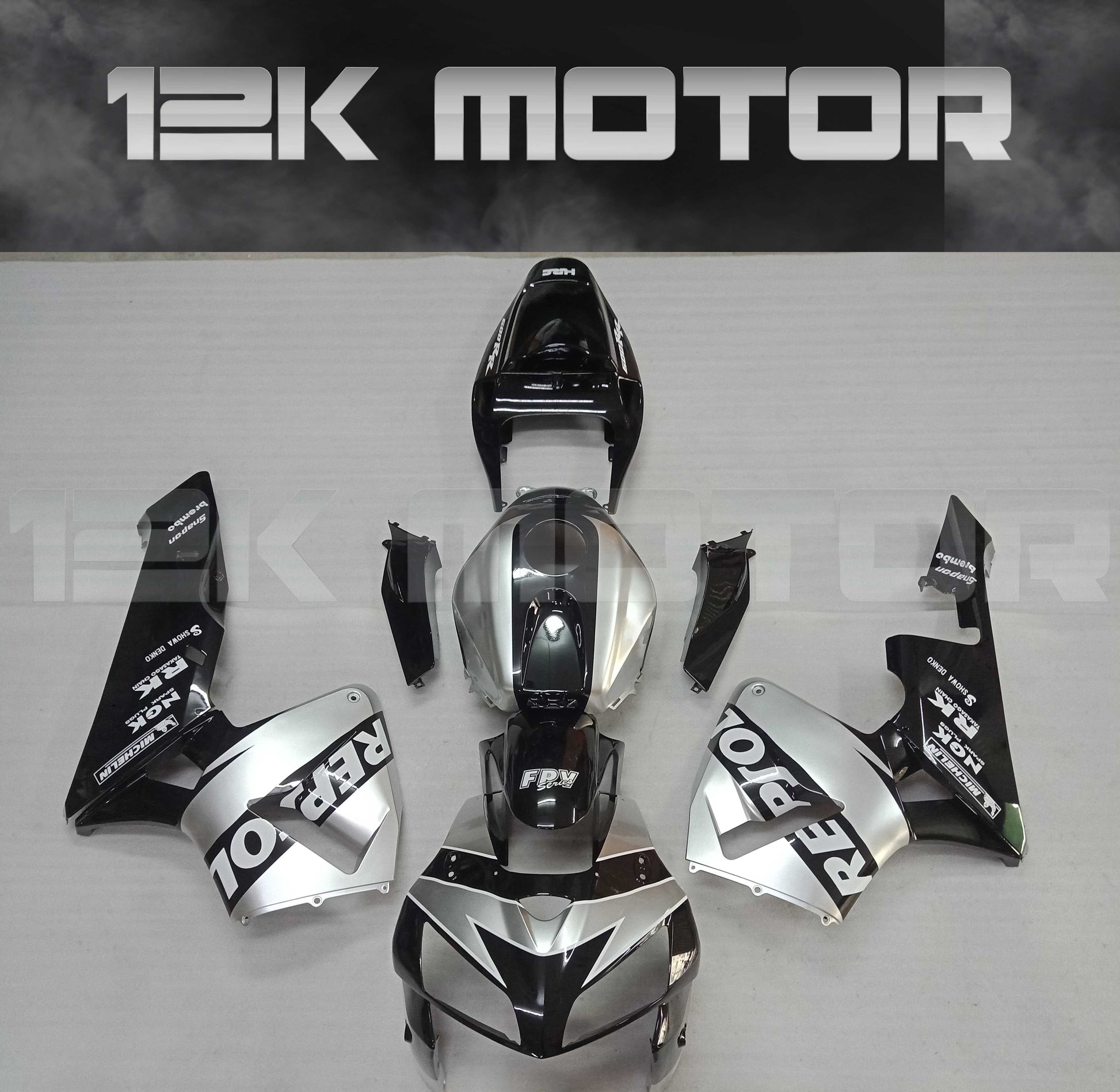 Aftermarket black and silver Repsol fairing kit for Honda CBR600RR motorcycle, displayed without being assembled.