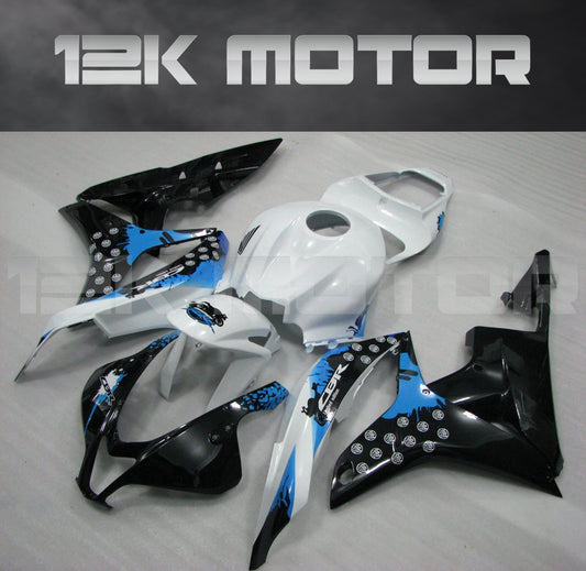 Aftermarket black, white, and blue fairing kit for Honda CBR600RR motorcycle, displayed on a table.