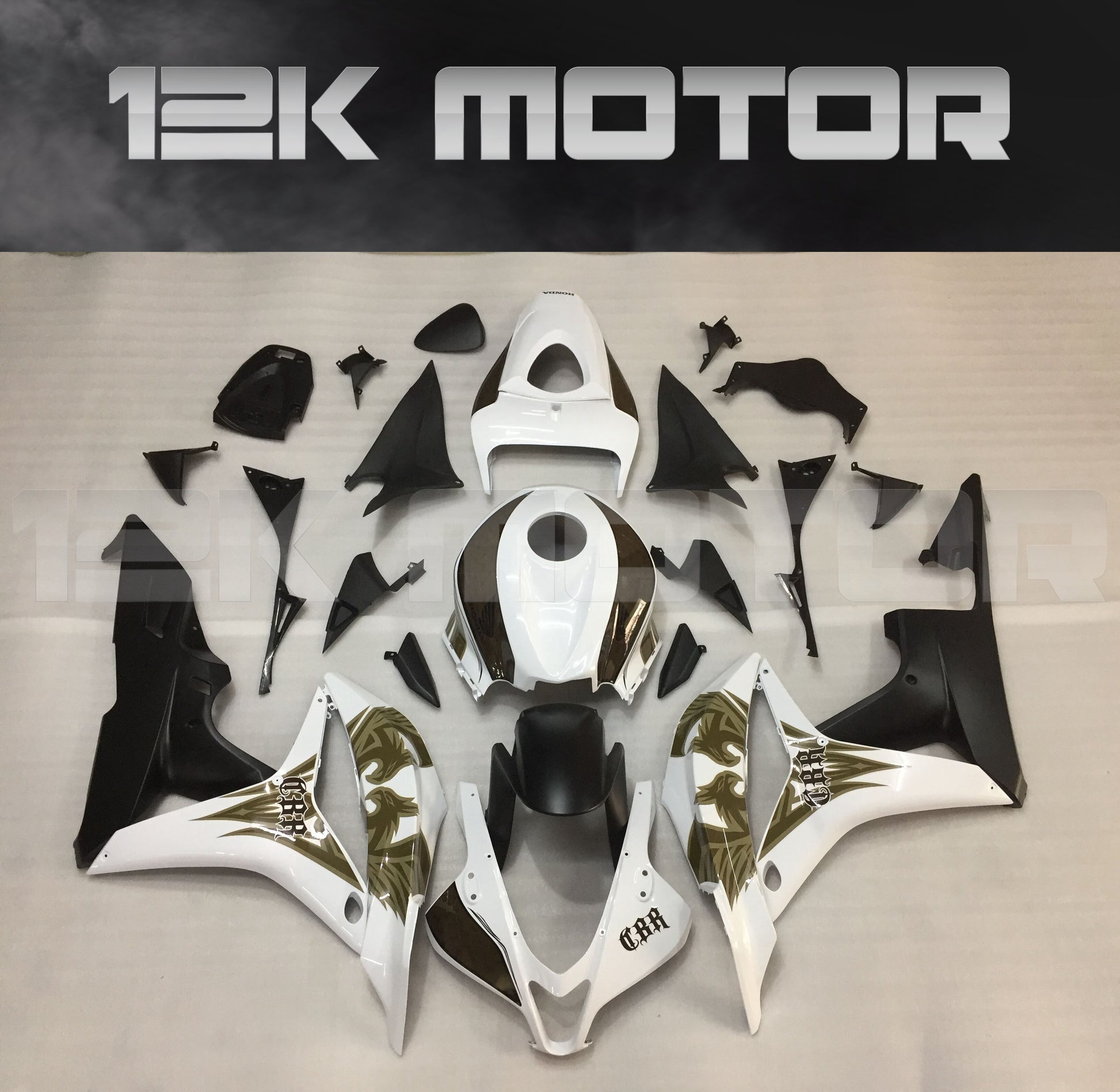 Aftermarket fairing kit for HONDA CBR600RR displayed on a table, featuring a black, white, and gold color scheme.