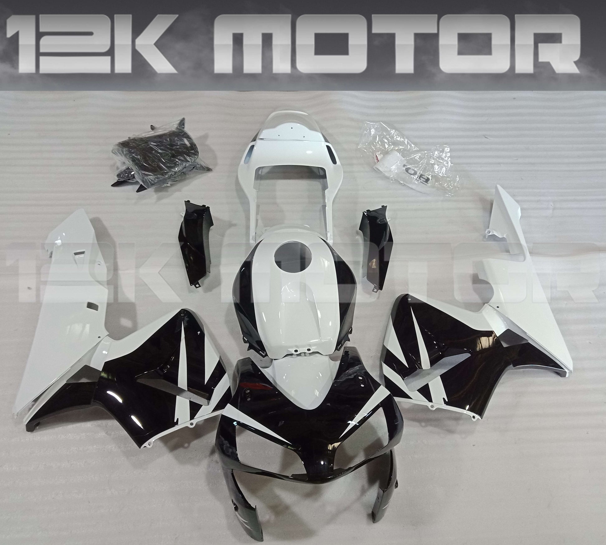 Aftermarket fairing kit for HONDA CBR600RR motorcycle, featuring black, white, and red panels, displayed with the 12K Motor brand logo.