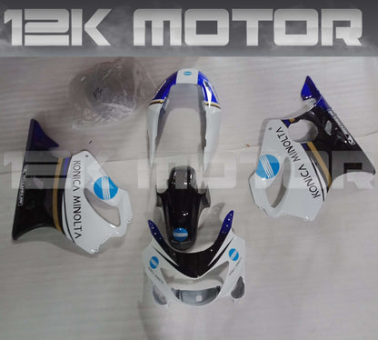 Aftermarket fairing kit for HONDA CBR600RR F4 1999 2000 displayed on a table, consisting of various motorcycle fairing pieces in black, white, and blue colors.