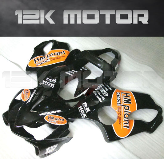 Aftermarket fairing kit for HONDA CBR600 F4i 2001-2003, displayed on a table, consisting of multiple black plastic panels with orange and white branding stickers.
