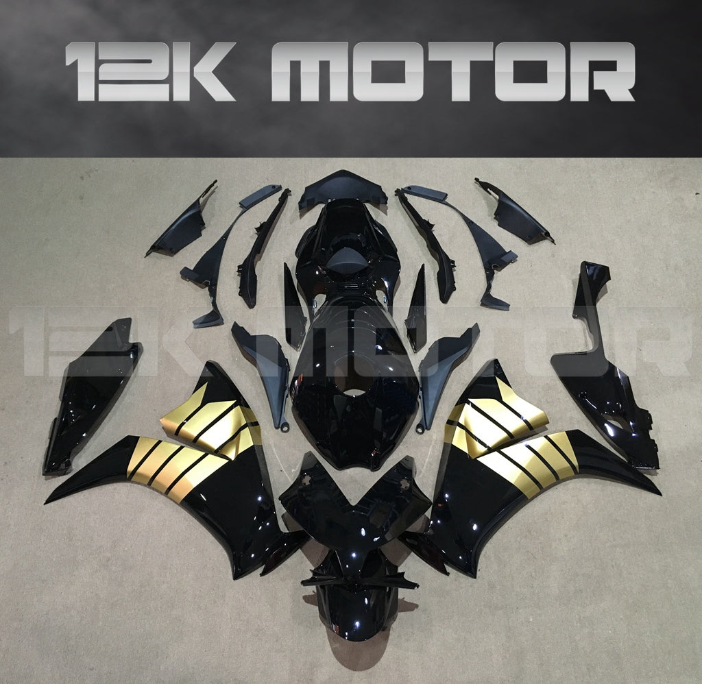 Aftermarket black and gold fairing kit for HONDA CBR1000RR laid out on a flat surface, including various panels and parts.