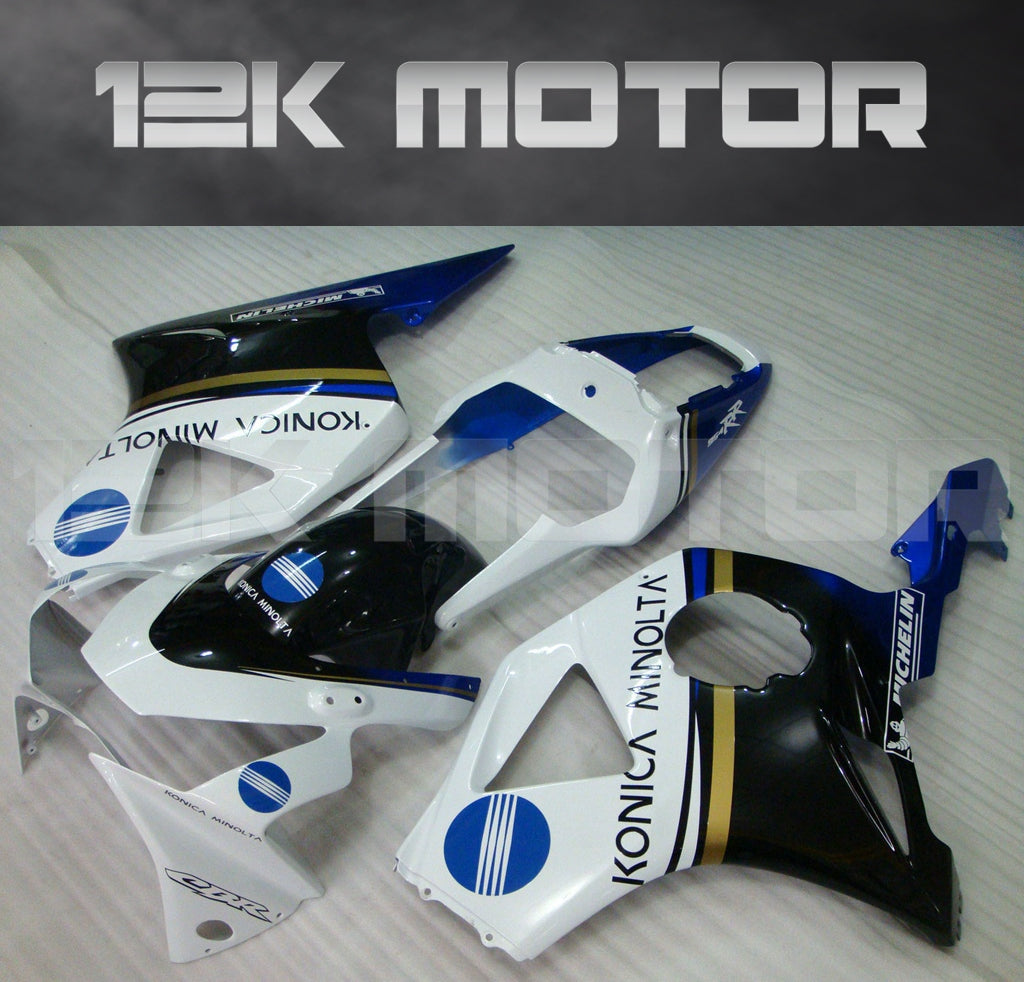Aftermarket fairing kit for HONDA CBR954RR motorcycle, displayed are multiple fairing pieces in black, white, blue, and yellow colors with brand decals and graphics.
