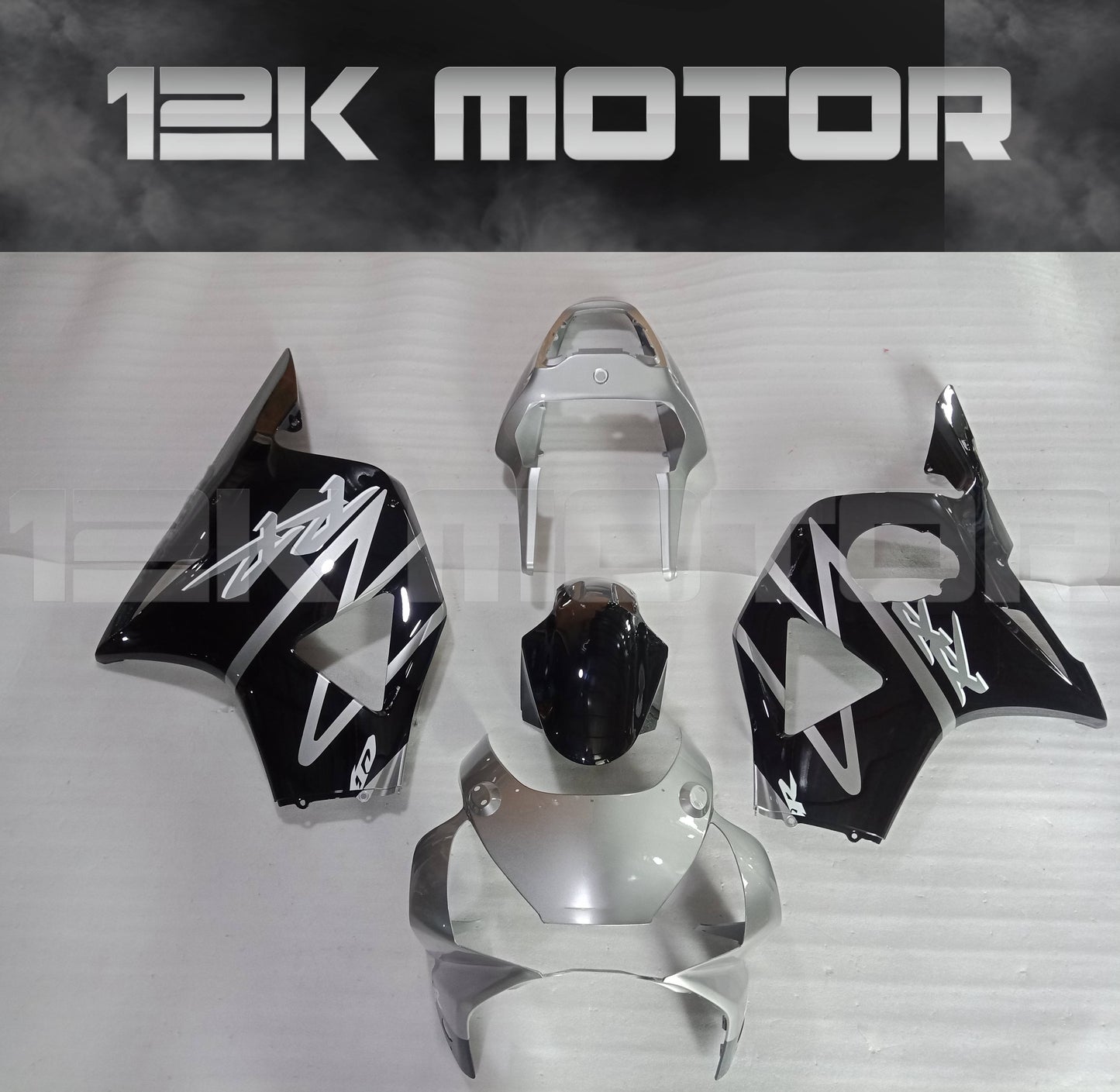 Aftermarket fairing kit for HONDA CBR954RR motorcycle, displayed are multiple pieces including upper fairing, lower fairing panels, and a windscreen, primarily in black and white design.