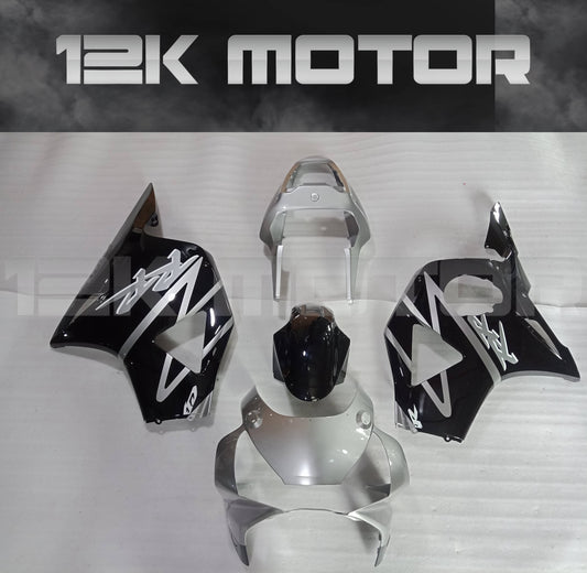 Aftermarket fairing kit for HONDA CBR954RR motorcycle, displayed are multiple pieces including upper fairing, lower fairing panels, and a windscreen, primarily in black and white design.