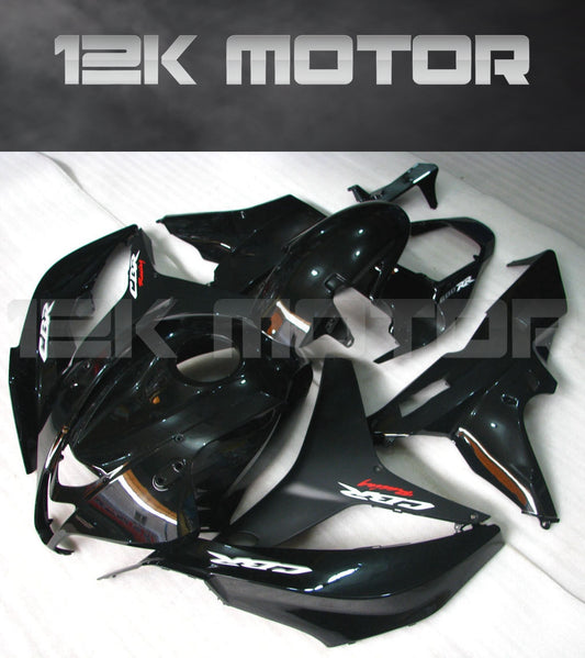 A set of gloss black motorcycle fairings for a HONDA CBR600RR, displayed on a table.