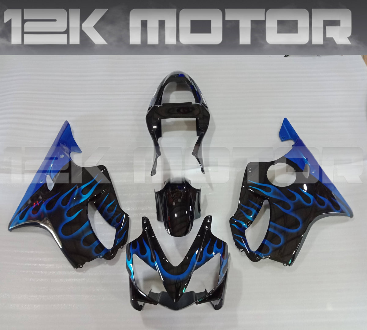 Aftermarket fairing kit for HONDA CBR600 F4i 2001 2002 2003 displayed on a table, featuring a blue and black color scheme with a flame design.