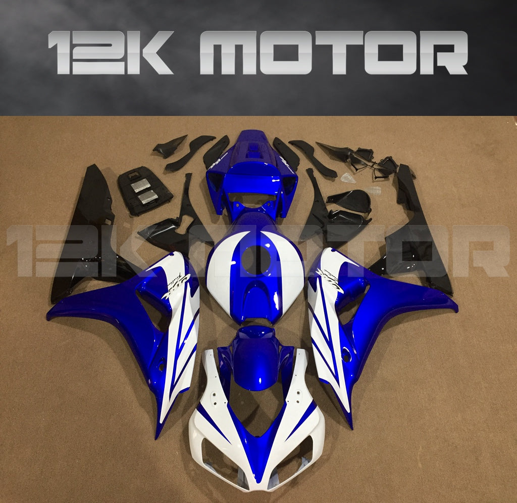 Aftermarket fairing kit for HONDA CBR1000RR motorcycle, featuring blue and white panels, along with various other panels and parts laid out on a table.