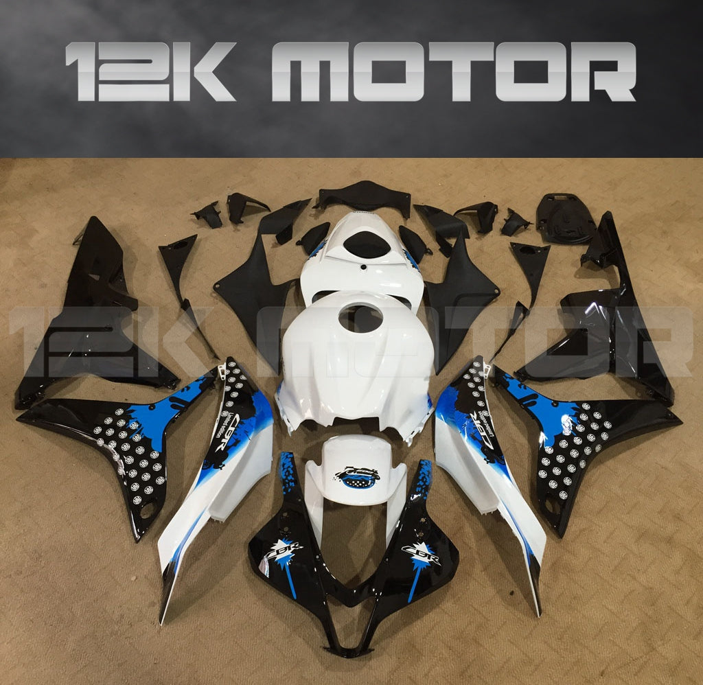 Aftermarket black, white, and blue fairing set for HONDA CBR600RR motorcycle, displayed on a table with the brand name '12K Motor' visible in the background.