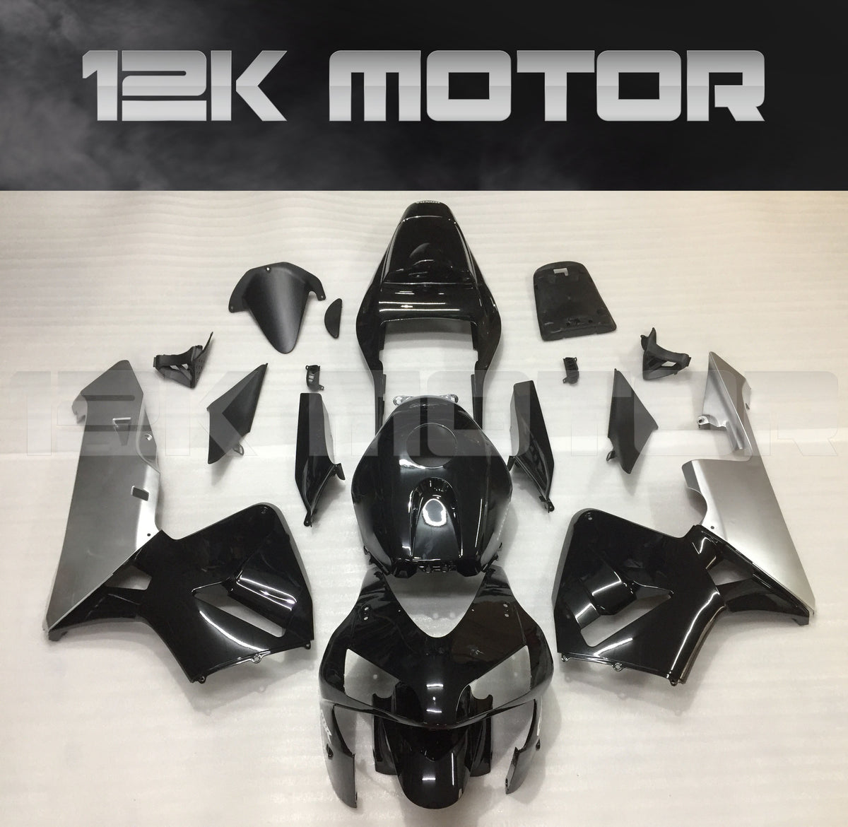 Aftermarket silver and black fairing kit for HONDA CBR600RR motorcycle, displayed on a table.