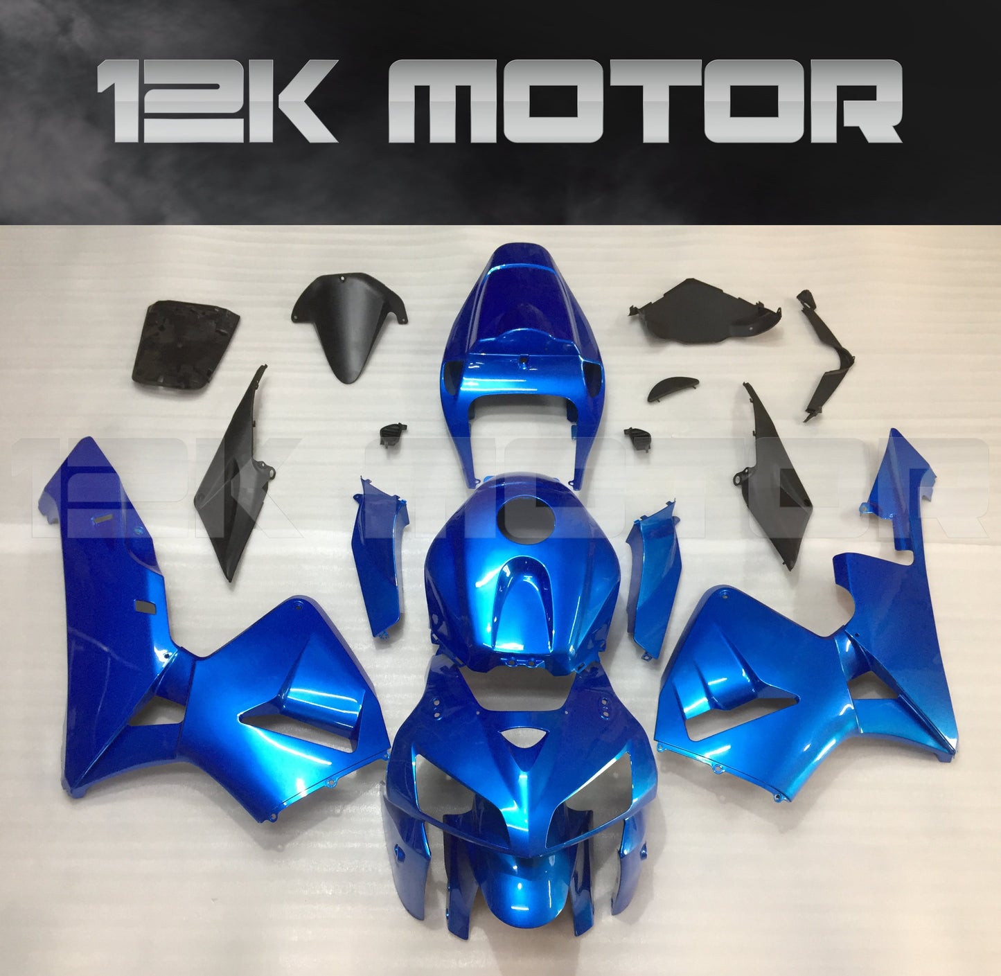 Aftermarket blue fairing kit for Honda CBR600RR motorcycle displayed on a table.
