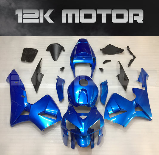 Aftermarket blue fairing kit for Honda CBR600RR motorcycle displayed on a table.