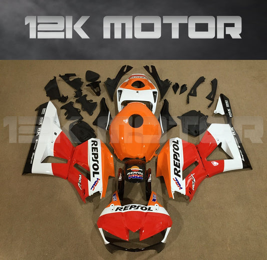 Aftermarket fairing kit for HONDA CBR600RR motorcycle, featuring a red, white, and black color scheme with Repsol branding, displayed on a table.