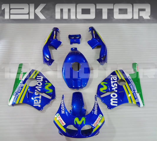 Aftermarket blue fairing kit for Honda CBR250 MC22 with decals, including various panels and parts, displayed on a table.