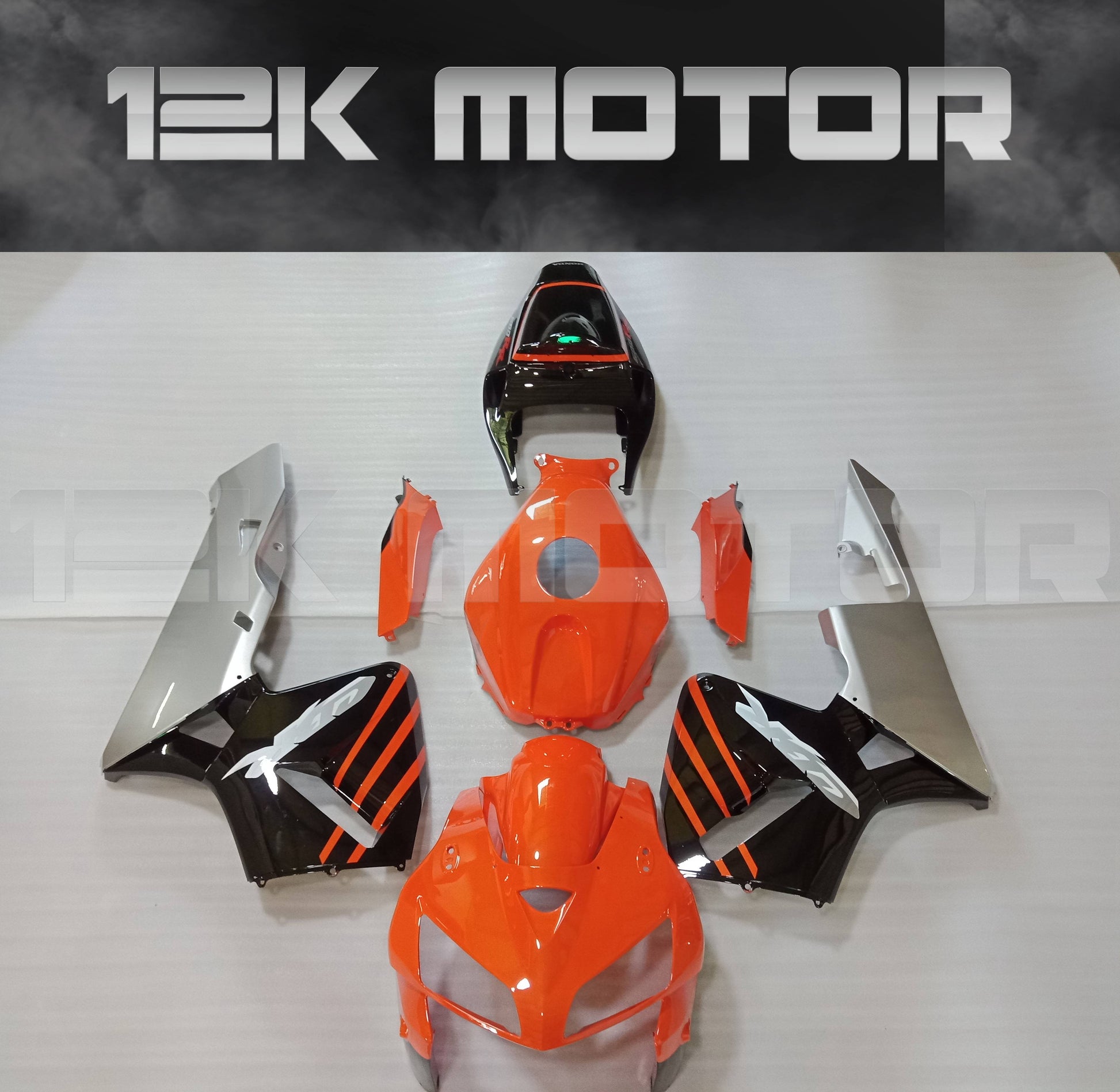 An orange motorcycle fairing kit for HONDA CBR600RR 2005 2006 displayed on a table with the brand name 12K Motor visible.
