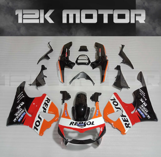 Aftermarket fairing kit for HONDA CBR900RR in orange, black, and white colors, including various panels and bolts, displayed on a plain background.