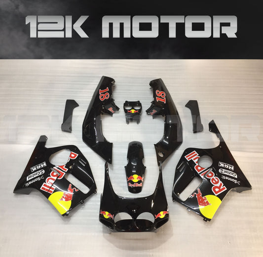 Aftermarket motorcycle fairing set for HONDA CBR250RR MC19 in black color with red bull branding.