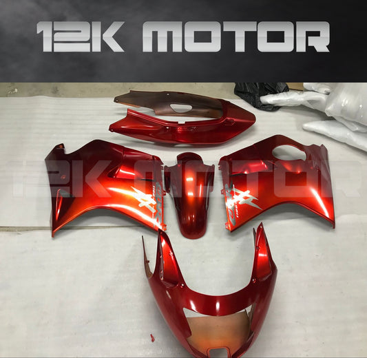 Red motorcycle fairing parts laid out on a white surface with the 12K Motor logo visible.